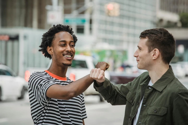 two men shaking hands on a city street, pexels contest winner, mix of ethnicities and genders, teenage boy, playful smirk, ignant