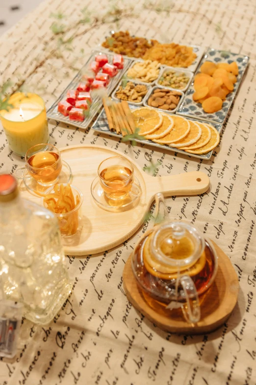 a table topped with plates of food and drinks, honey, peaceful mood, board games on a table, tea