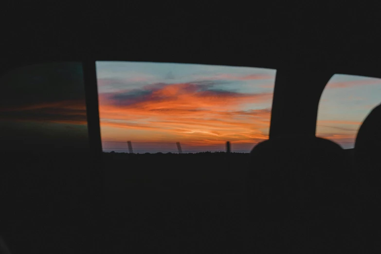 a sunset seen through the window of a car, by Adam Pijnacker, unsplash contest winner, vsco film grain, red skies, tv still frame, pc screen image