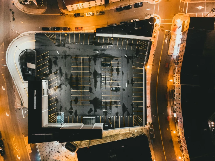 an aerial view of a parking lot at night, pexels contest winner, upside - down building, square, thumbnail, cinematic footage