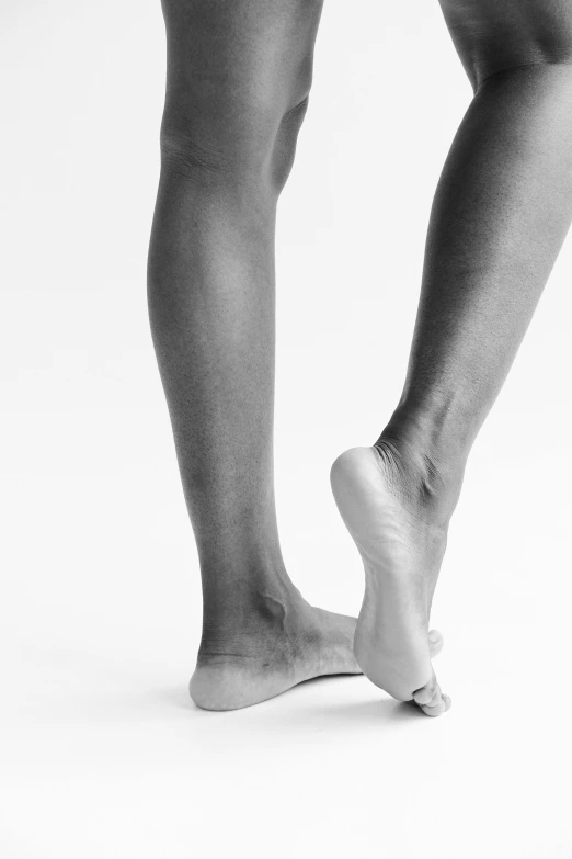 a black and white photo of a woman's legs, by Clifford Ross, arabesque, studio shoot, -step 50, concern, max dennison