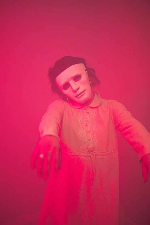 a creepy doll standing in front of a red light, pink face, press photos, ( ( mask ) ), ignant