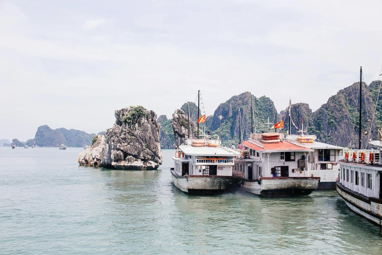 a number of boats in a body of water, by Carey Morris, pexels contest winner, vietnamese temple scene, two medium sized islands, shaped like a yacht, 90s photo