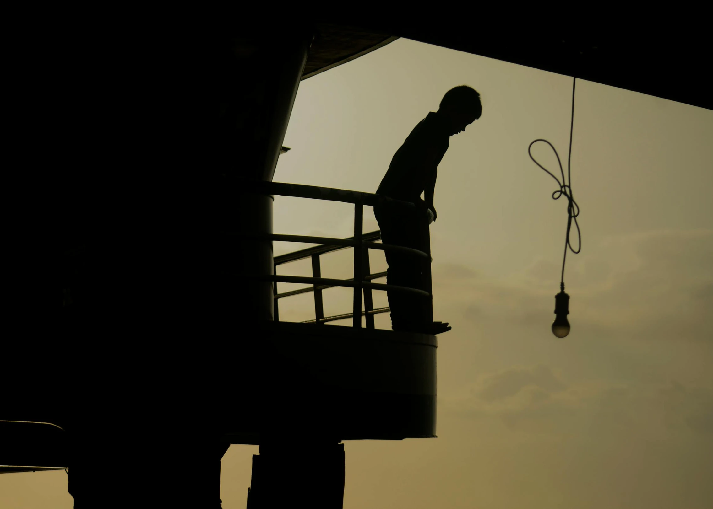 a silhouette of a man standing on a balcony, by Eglon van der Neer, pexels contest winner, figuration libre, standing on ship deck, mechanic, hanging rope, concerned