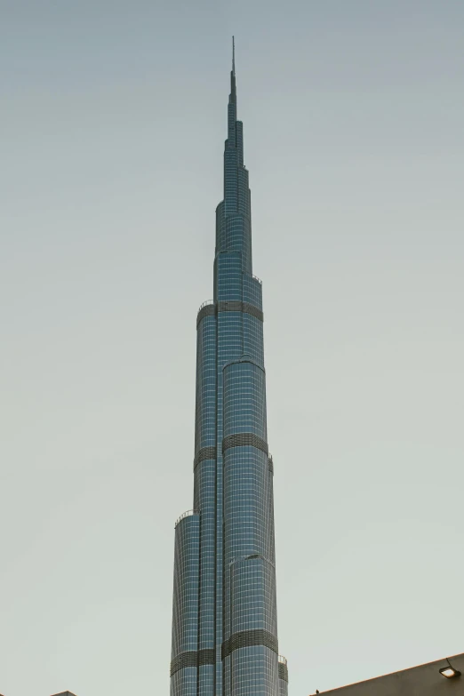 a tall building in the middle of a city, gta : dubai, cinematic shot ar 9:16 -n 6 -g, hyperdetailed photorealism”, lead - covered spire