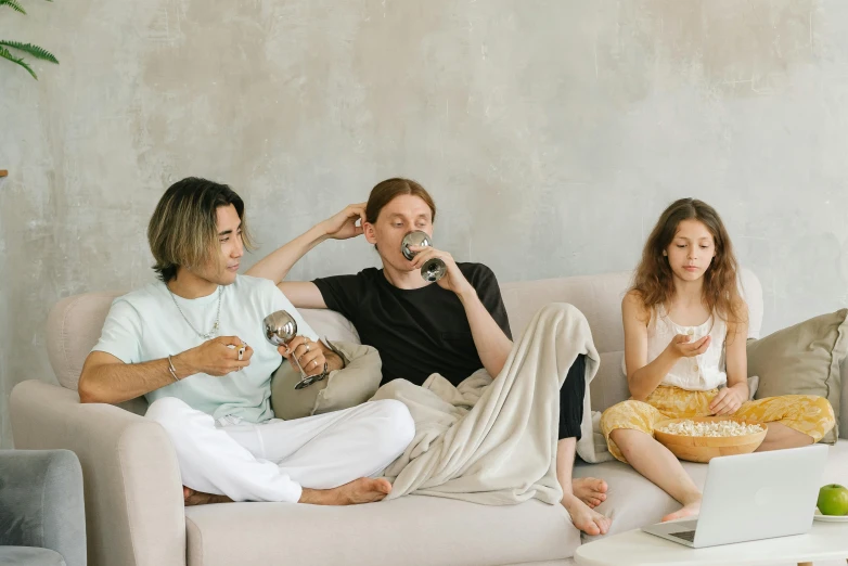 a group of people sitting on top of a couch, trending on pexels, cold drinks, wearing a baggy pajamas, profile image, background image