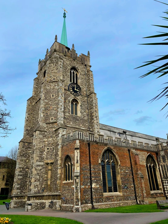 a large brick church with a green steeple, by Kev Walker, pexels, payne's grey and venetian red, thumbnail, cathedral!!!!!, silver