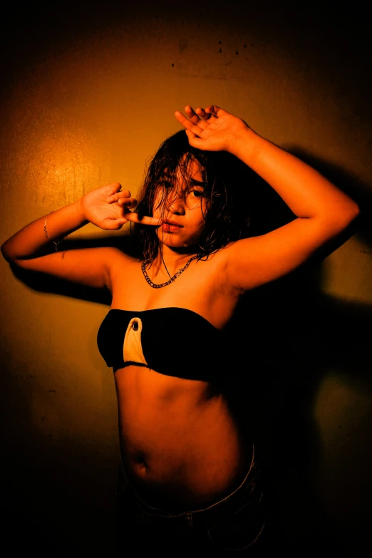 a woman in a bikini posing for a picture, an album cover, inspired by Nan Goldin, unsplash, sumatraism, cold lighting, teenage, high quality photo, exotic expression