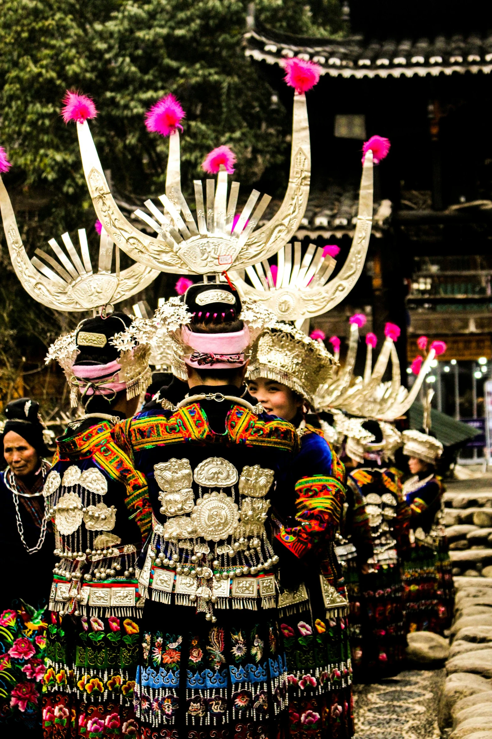 a group of people standing next to each other, an album cover, inspired by Miao Fu, pexels contest winner, intricate outfit, rear-shot, bling, chinese village