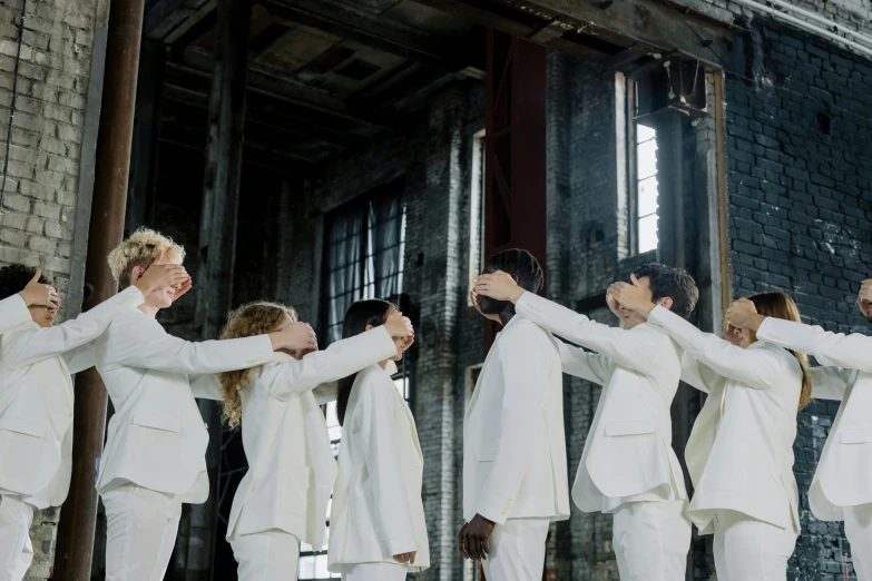 a group of men in white suits standing next to each other, an album cover, by Nina Hamnett, pexels contest winner, holding his hands up to his face, offwhite, biennale, cai xukun