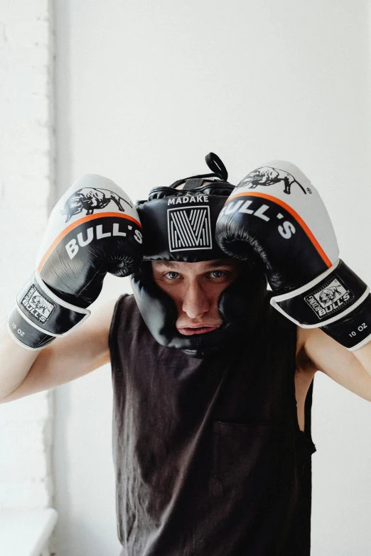 a close up of a person wearing boxing gloves, two horns on the head, young adult male, striking a pose, headspace
