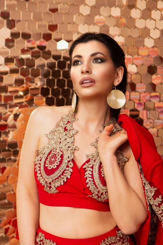 a woman in a red outfit posing for a picture, an album cover, inspired by Lubna Agha, arabesque, intricate led jewellery, demur, elegant decollete, lookbook