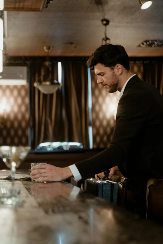 a man in a suit standing at a bar, inspired by Ramon Pichot, unsplash, renaissance, adam driver, ( ( theatrical ) ), slide show, lounge