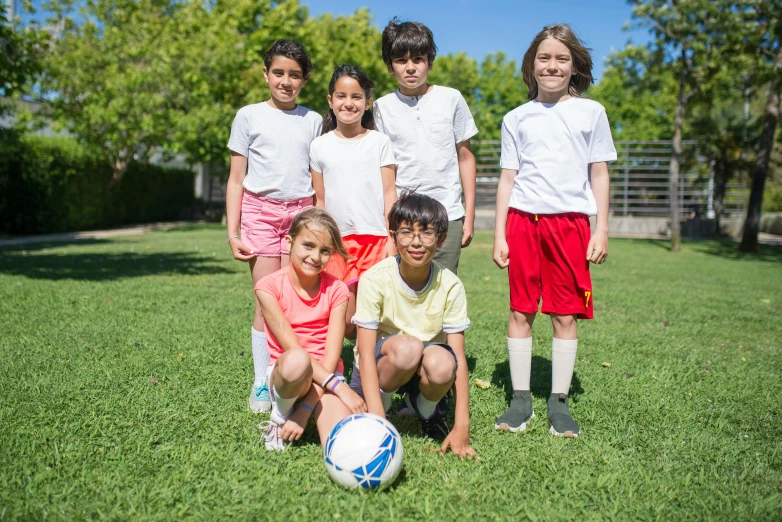 a group of children posing for a picture with a soccer ball, a picture, pexels contest winner, ashcan school, sunny day time, profile image, thumbnail, full body image