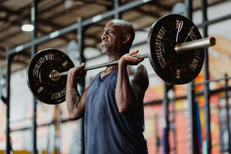a man lifting a barbell in a gym, a portrait, by Matija Jama, pexels contest winner, george floyd, aged 4 0, profile image, 70 years old