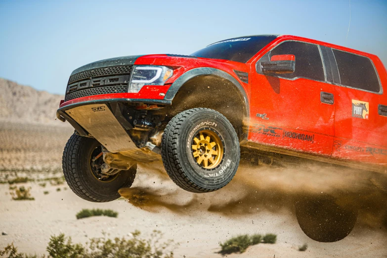 a red truck is flying through the air, pexels contest winner, ford f-150 raptor, trophy truck, thumbnail, deus ex machina