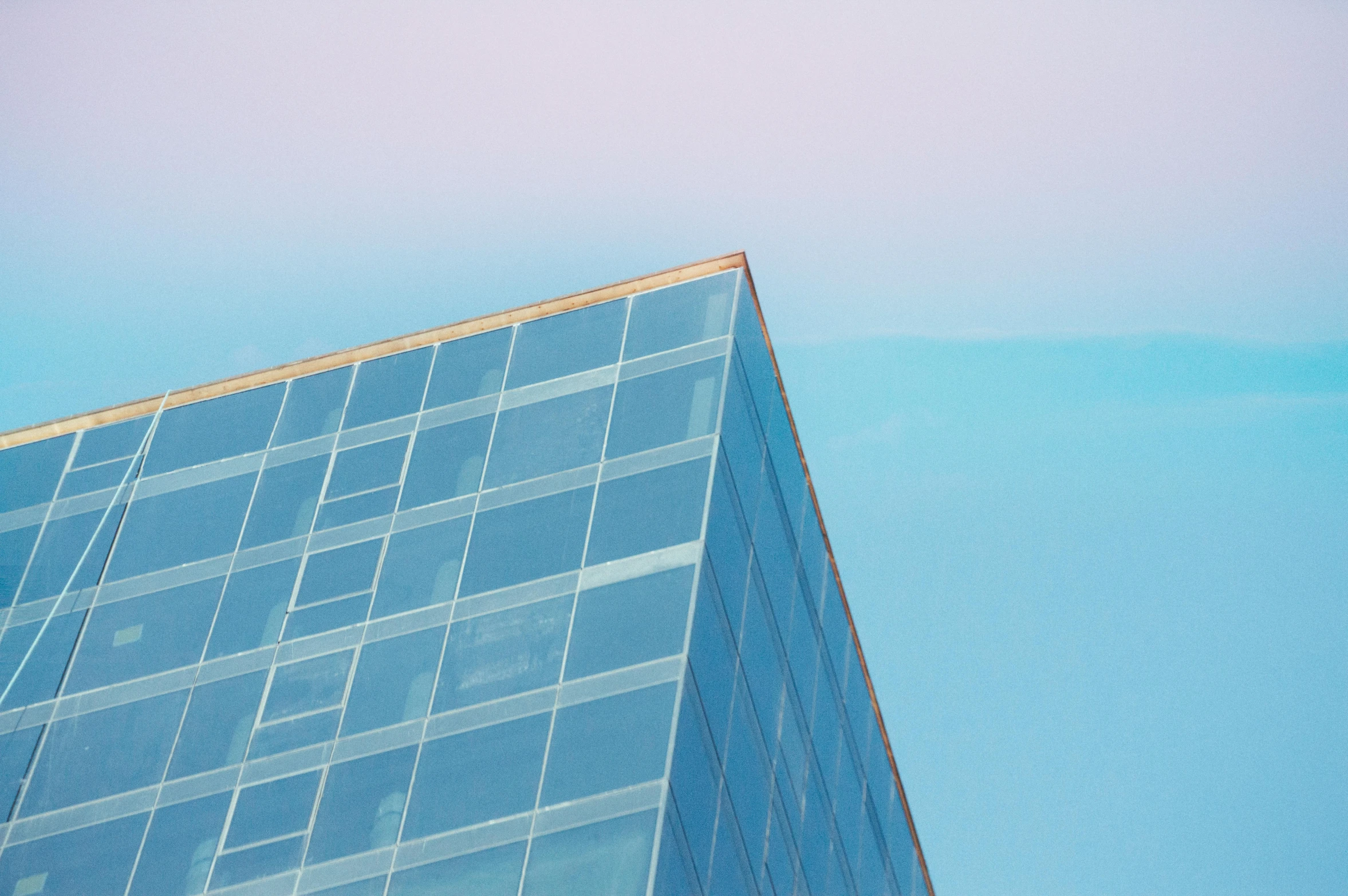 a plane flying through a blue sky next to a tall building, an album cover, unsplash contest winner, hypermodernism, iridescent glass, ignant, pastel blue, james turrell