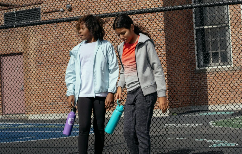 two girls standing next to each other on a tennis court, trending on unsplash, graffiti, water bottles, mauve and cinnabar and cyan, official product image, hero shot