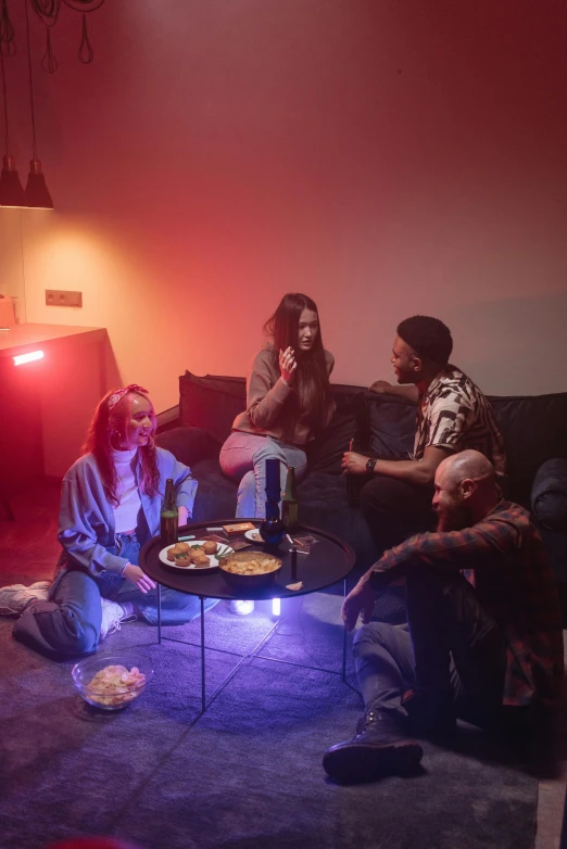 a group of people sitting on a couch in a living room, a hologram, trending on pexels, happening, bisexual lighting, party lights, smokey room, urban surroundings