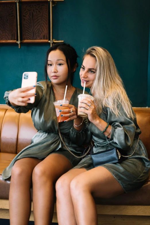 two women sitting on a couch taking a selfie, by Adriaen Hanneman, trending on instagram, happening, drinking boba tea, exposed thighs, influencer, sitting at the bar