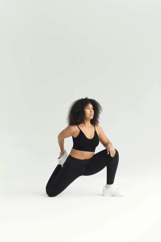 a woman in a black sports bra top and leggings, unsplash, arabesque, crouching humanoid, set against a white background, product introduction photo, seamless