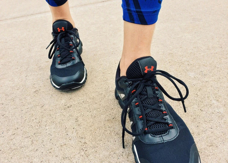 a close up of a person's shoes on a sidewalk, workout, avatar image, black and orange, bumps