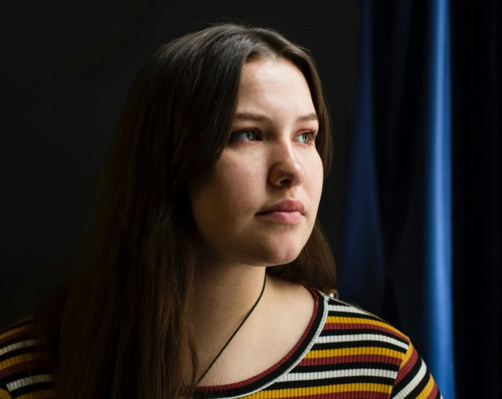 a woman standing in front of a blue curtain, profile image, portrait sophie mudd, photographed for reuters, andrea savchenko