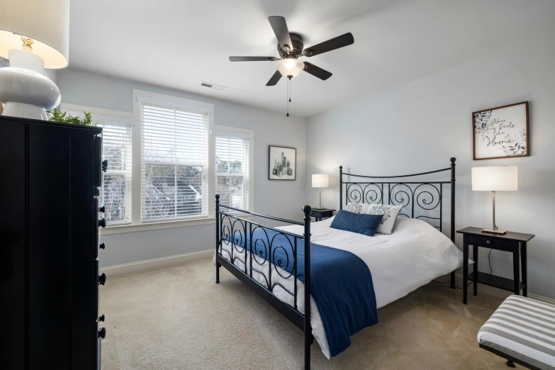 a bed room with a neatly made bed and a ceiling fan, by Carey Morris, unsplash contest winner, soft grey and blue natural light, wrought iron, listing image, 120 degree view