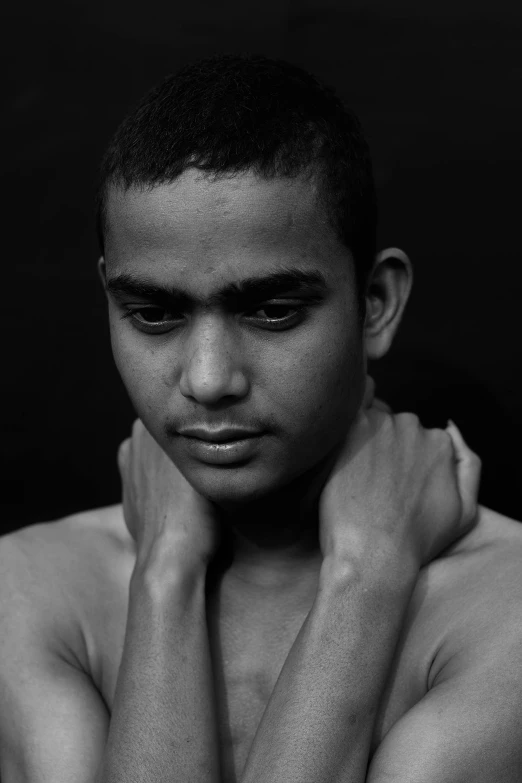 a black and white photo of a young man, an album cover, inspired by Sunil Das, flickr, light-brown skin, taken in the late 2000s, ignant, solemn gesture
