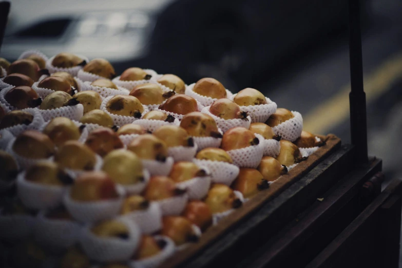 a box of apples sitting on top of a table, bakery, alessio albi, piping, in a row