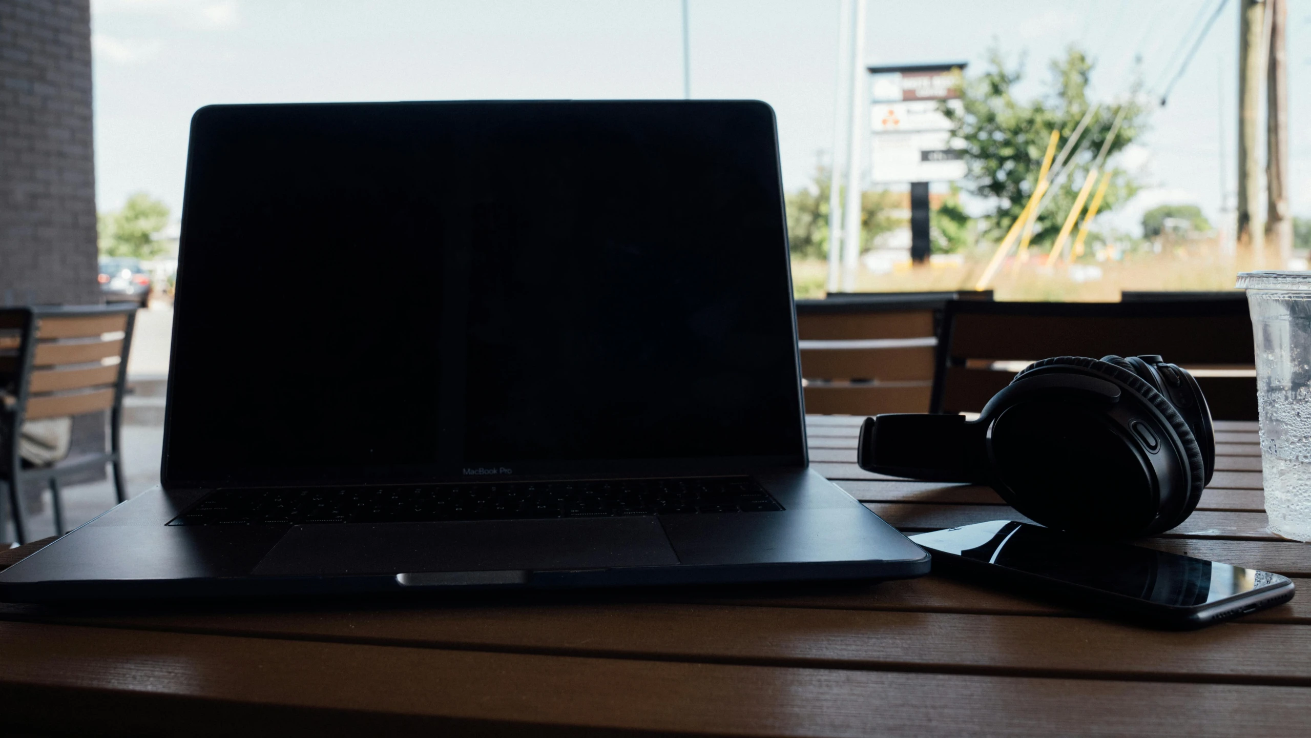 a laptop computer sitting on top of a wooden table, unsplash, background image, screenwriter, high quality image”