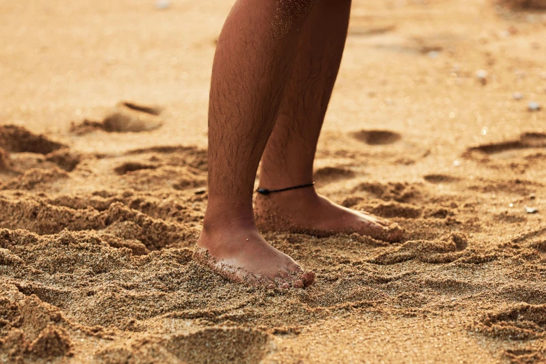 a man standing on top of a sandy beach, unsplash, renaissance, close-up on legs, brown, unshaven, slide show