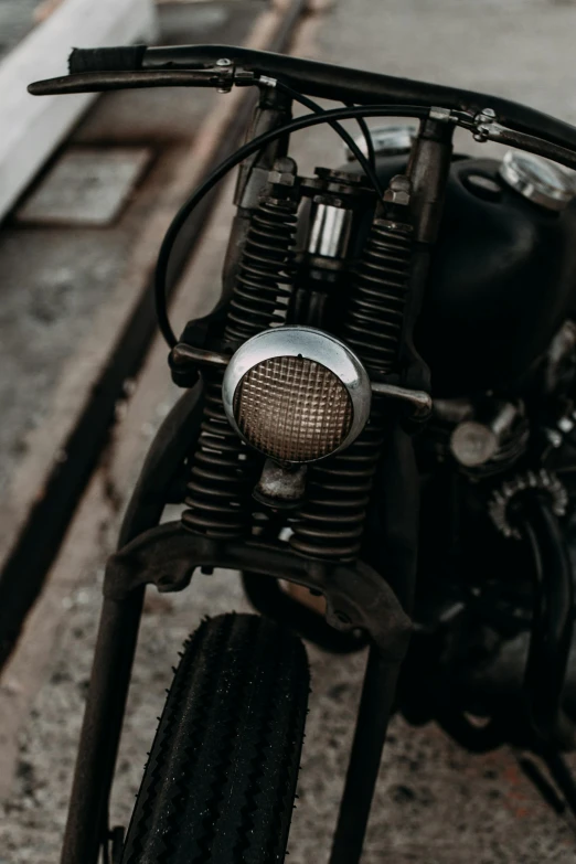 a close up of a motorcycle parked on a street, by IAN SPRIGGS, pexels contest winner, metallic light, built on a small, unfinished, a pair of ribbed