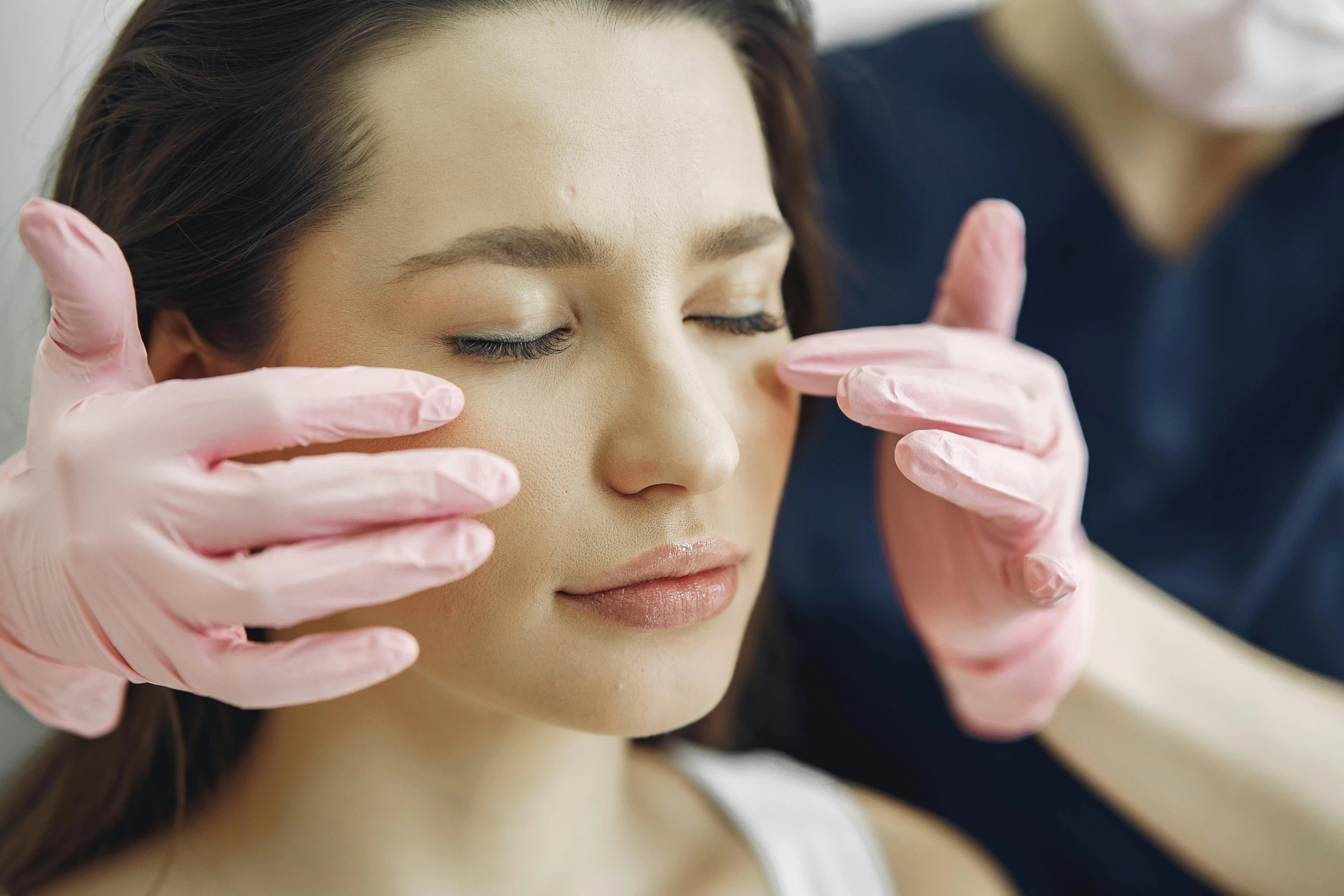 a woman getting her eyebrows done at a beauty salon, by Joe Bowler, trending on pexels, renaissance, hand on his cheek, long pointy pink nose, plastic skin, face photo