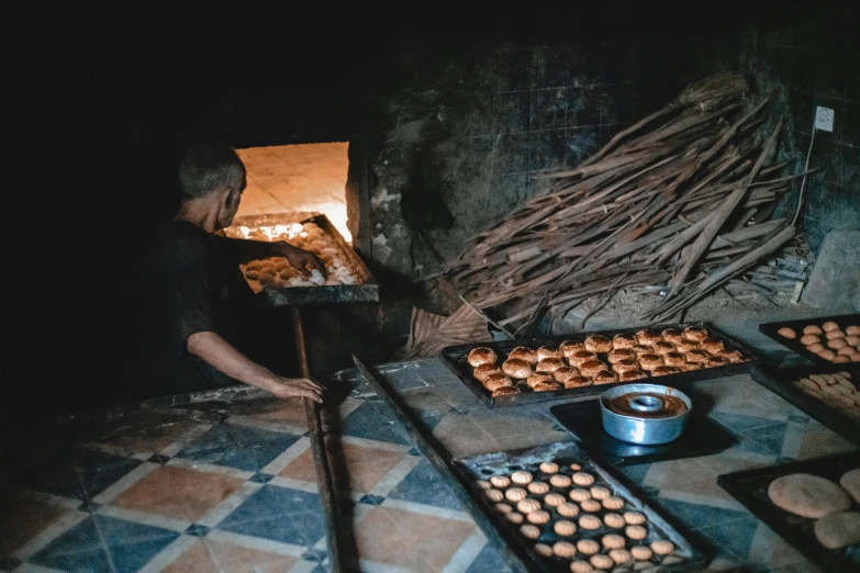 a man that is standing in front of a oven, pexels contest winner, les nabis, vietnam, crispy buns, inside of a cabin, moroccan