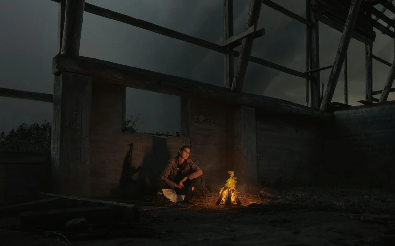 a man sitting next to a fire in a building, inspired by Gregory Crewdson, pexels contest winner, conceptual art, ismail inceoglu and ruan jia, cinematic outdoor lighting, post apocalypse, quixel megascan