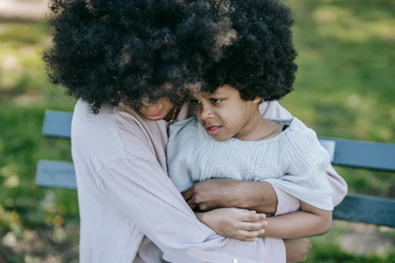 a mother hugging her daughter on a park bench, by Lily Delissa Joseph, pexels contest winner, long afro hair, sydney park, bedhead, fatherly