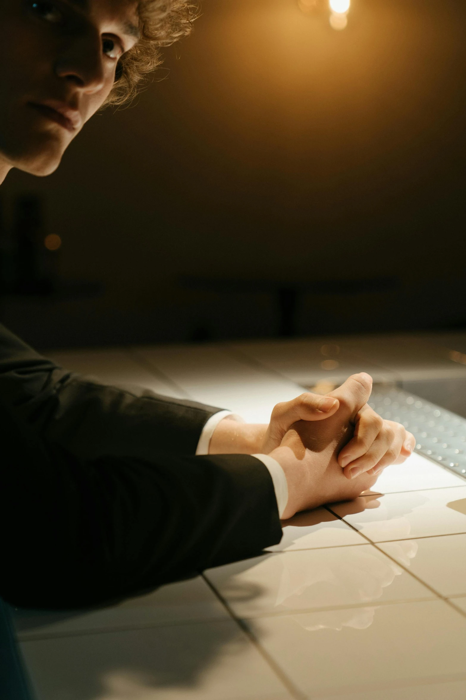 a man sitting in front of a laptop computer, by Jason Felix, unsplash, arm wrestling, somber lighting, man in black suit, puzzling