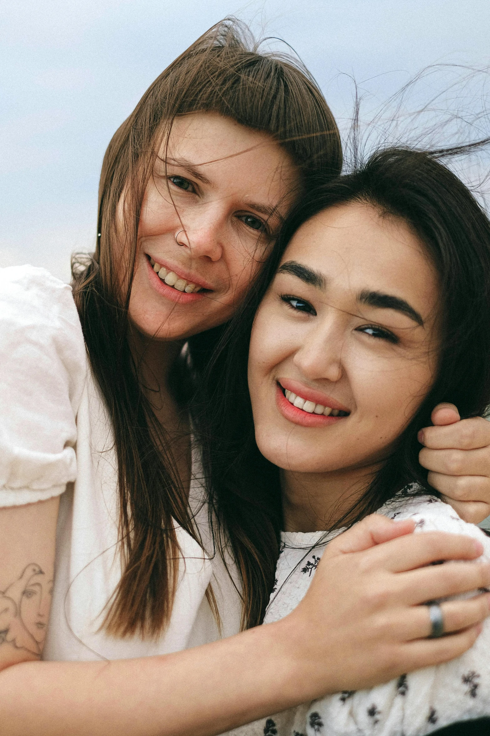 a couple of women standing next to each other, a picture, trending on pexels, portrait of women embracing, non binary model, russian and japanese mix, 15081959 21121991 01012000 4k