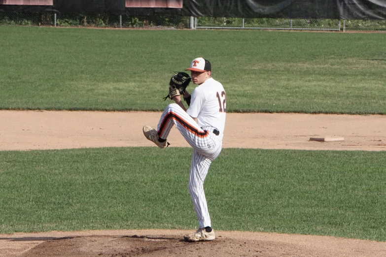a baseball player pitching a ball on top of a field, pitchburn devils, photo taken in 2 0 2 0, facing sideways, upon a peak in darien