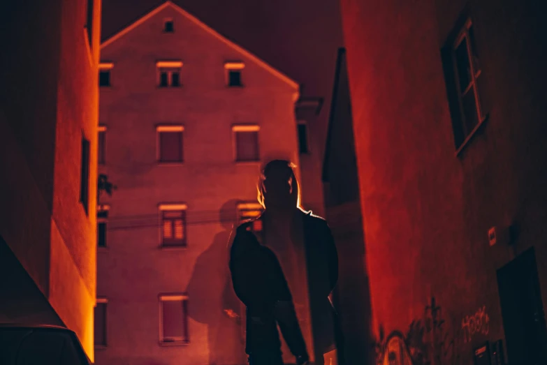 a man holding a surfboard in front of a building, by Adam Marczyński, pexels contest winner, conceptual art, dim red light, portrait of a vigilante, standing outside a house, hiding in the rooftops