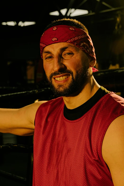 a man posing for a picture in a boxing ring, inspired by Volkan Baga, dribble, renaissance, red bandana, production still, big smirk, lumberjack