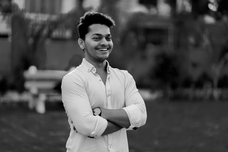 a black and white photo of a man with his arms crossed, a black and white photo, inspired by Bikash Bhattacharjee, cute smile, trending on artist, smiling :: attractive, architect