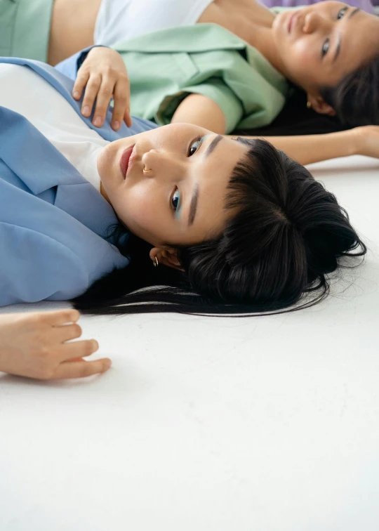 a couple of women laying on top of a bed, by Fei Danxu, trending on unsplash, hyperrealism, sui ishida with black hair, bored expression, on ground, promotional image