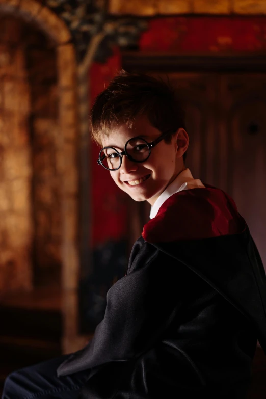 a young man dressed in a harry potter costume, inspired by Fuller Potter, in the magic room, highly upvoted, classical robes, upclose