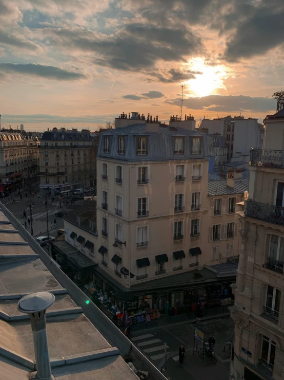 a view of a city from the top of a building, a photo, unsplash contest winner, paris school, evening sunlight, taken on iphone 14 pro, a quaint, market