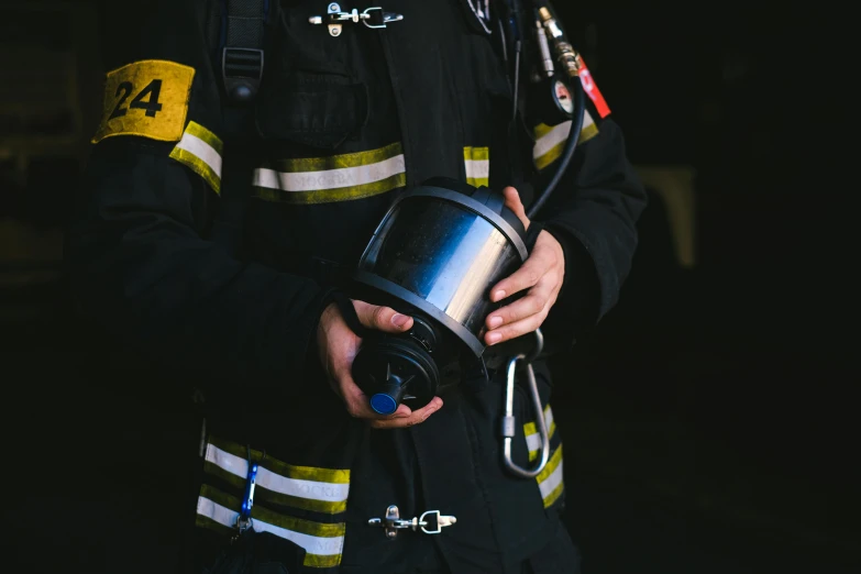 a close up of a person wearing a fireman uniform, pexels contest winner, hurufiyya, holding a tin can, steel collar, avatar image, nebulizer equipment