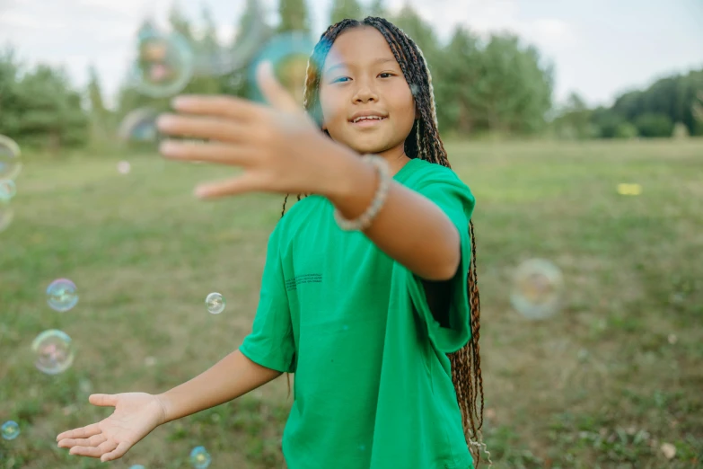 a little girl standing on top of a lush green field, pexels contest winner, floating bubbles, black teenage boy, avatar image, girl with plaits