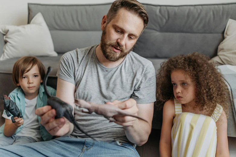 a man sitting on the floor playing a video game, by Adam Marczyński, pexels contest winner, hyperrealism, portrait of family of three, 15081959 21121991 01012000 4k, animal crossing character, perfect android girl family
