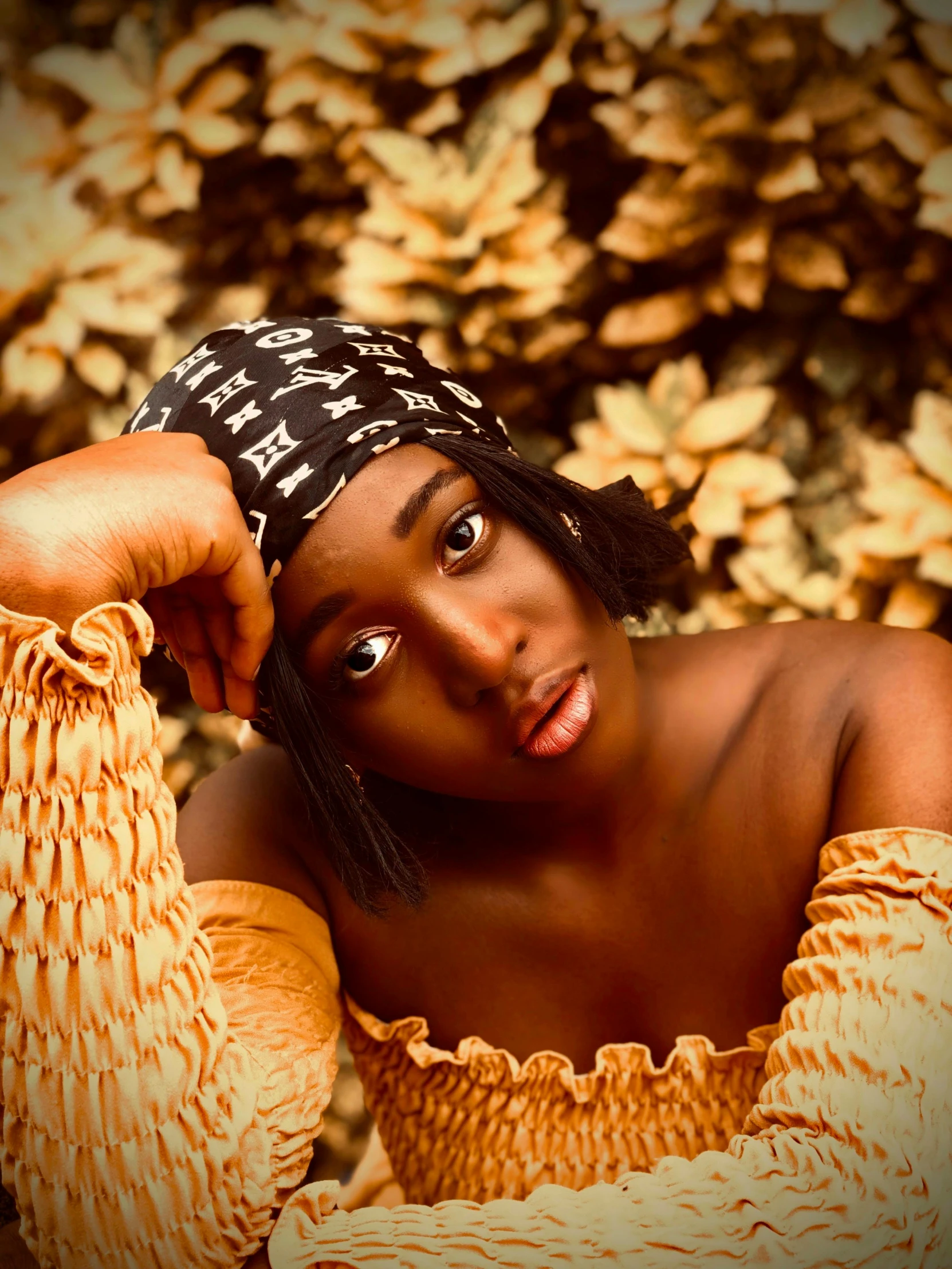 an image of a woman posing for a picture, an album cover, by Chinwe Chukwuogo-Roy, trending on pexels, wearing a turban, muted brown yellow and blacks, ☁🌪🌙👩🏾, bright soulful eyes